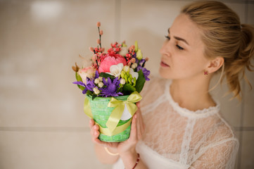 Girl smells small bouquet in a box