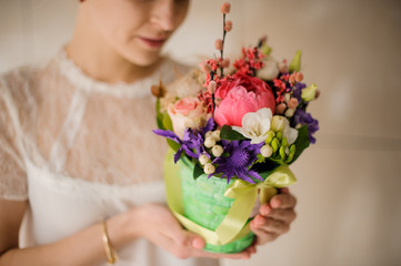 Girl holds small bouquet in a box