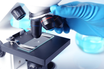 Scientist working with modern microscope, closeup. Chemical research