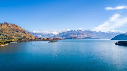 Pristine lake at a sunny day with mountains on the background. Wanaka, Otago, South Island, New Zealand