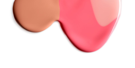 Different color nail polishes flowing on white background