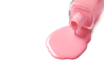 Spilled color nail polish with bottle on white background