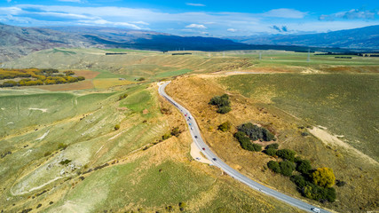 Road running through hills and farmland. Otago, South Island, New Zealand