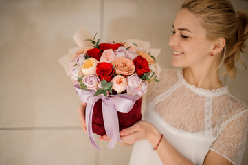 Happy girl holding a bouquet of roses
