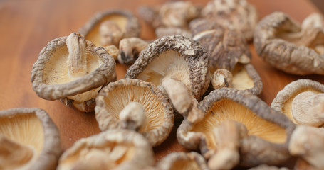 Stack of dry mushroom on wooden plate