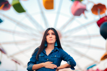 Woman Having Motion Sickness on Spinning Ferris Wheel Background