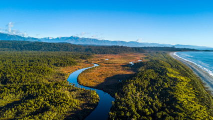 River running to the Tasman sea trough the native forest. West Coast, South Island, New Zealand