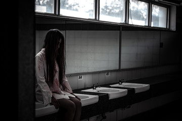 Portrait of asian woman make up ghost face with blood,Horror scene,Scary background,Halloween...