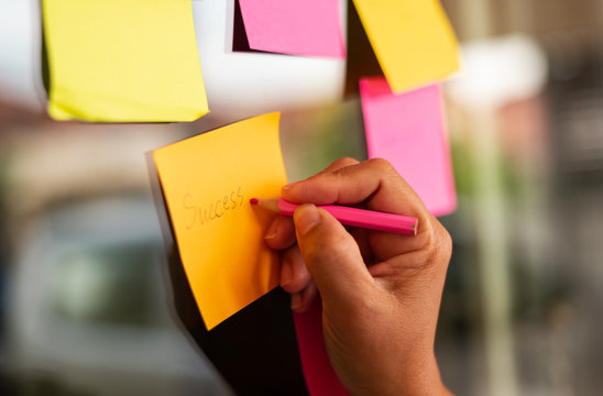 Close up businessman hands holding note sticky for brainstorm ans share idea strategy workshop business.Brainstorming concept