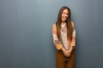 Young hippie woman funnny and friendly showing tongue