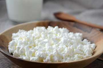 Cottage cheese in a wooden bowl. Farm products. Village Breakfast