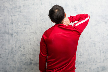 Obraz na płótnie Canvas Young sport fitness chinese from behind thinking about something