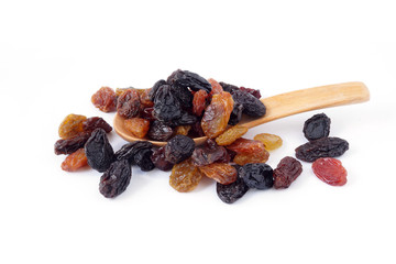 Raisins or Dried grapes mix color black, red, green with wooden spoon isolated on white background
