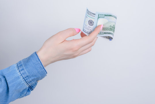 Cropped closeup side profile photo portrait of hands holding showing one hundred dollars isolated over grey background