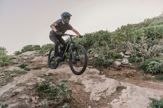 Spain, Lanzarote, mountain biker on a trail in the mountains