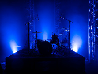 Drum set on the stage of a concert hall or club in a beautiful bright light. Drum set at a rock concert