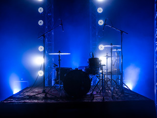 Drum set on the stage of a concert hall or club in a beautiful bright light. Drum set at a rock...