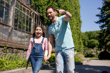 Father with daughter with laptop in park