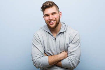 Young handsome fitness man laughing and having fun.