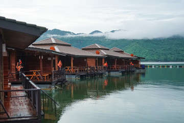 Naklejka premium wooden floating raft house resort by mountain Kanchanaburi, Thailand