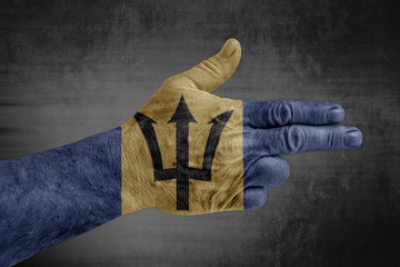 Barbados flag painted on male hand like a gun