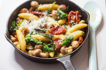 Potato dumplings, spinach, sun dried tomatoes and courgette in cheese sauce 