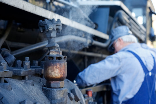 Working on an old steam train
