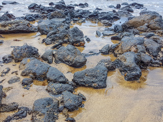 a view of sandy and rocky coastline on a beach in Lanzarote, Canary Islands, Spain