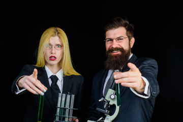 Science. Experiment. Chemistry. Test tubes. School. Education. Biology. Smiling woman with chemical test tubes. Bearded man with microscope. Laboratory. Analysis. Progressive school.