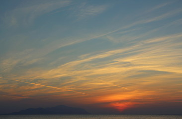  Dawn on the beach. Sun and sea in the early morning. Beautiful seascape.