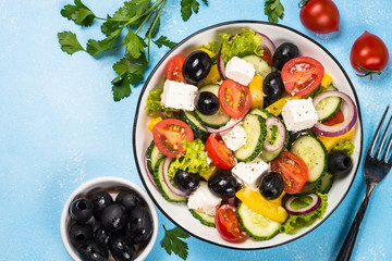 Greek salad on blue table.