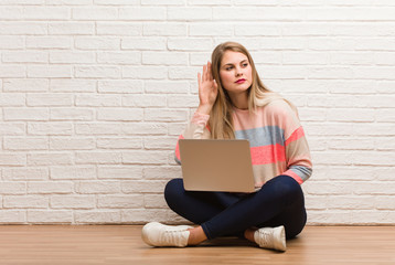 Young russian student woman sitting try to listening a gossip