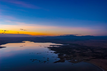 Fototapeta na wymiar Kenya. Africa. Lake Nakuru coast. Sunset on lake Nakuru in Kenya. African colorful sunset. Nature landscapes Africa.