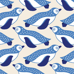 Fototapeta premium Sweet swimming penguin seamless repeat pattern in blue and white. Vector geometric sea bird design ideal for children.