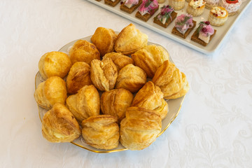 Appetizer plate. Luxury banquette Delicious food. Puff pastry pies. Fresh baked pies on white plate. Banquette table. Restaurant vip menu. Gourmet concept.