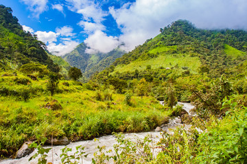 South America. Ecuador. Ecuadorian Andes with tops covered with clouds. The Pastaza River between the mountains. Mountain landscape of Ecuador. Sightseeing In Ecuador.