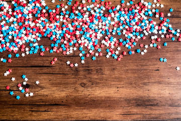 American Independence day background with blue, white and red mixed stars. Celebration of American independence day, the 4th of July (the Fourth of July). Holiday concept. Top view. With copy space. 