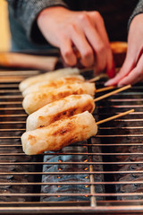 Grilled Cheese Stick on gas griller stove, street food at Ximending in Taiwan, Taipei.