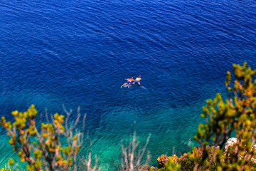 Fototapeta na wymiar Two guys snorkeling close to Vis island, Croatia