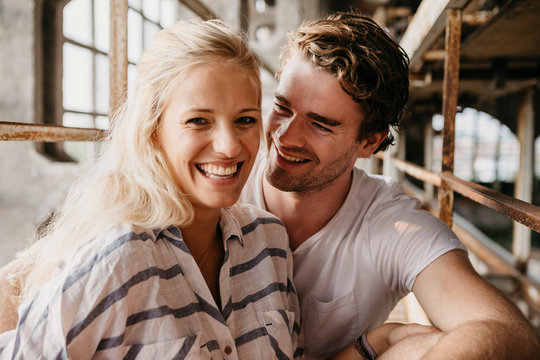 Portrait of happy young couple in an old building