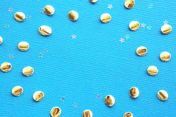 Texture and background Golden confetti and transparent stars on a light blue textural background. Space for text...
