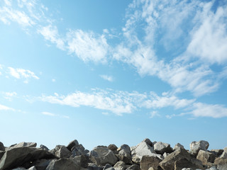Granite stones and blue sky with white clouds...