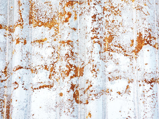 Fog and texture corrugated sheet of iron with rust appearing through the white paint...