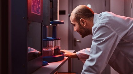Expirienced watchmaker is working with autoclave at his own studio.