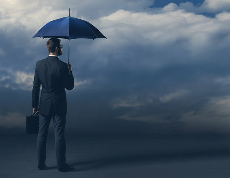 Businessman in formalwear over dark background. Business, finance, career and office concept.