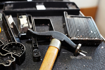 Naklejka premium Various leather processing tools and utensils used to produce leather items, handbags, shoes