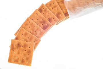 Whole Wheat Crackers Spilling From Package Isolated On White