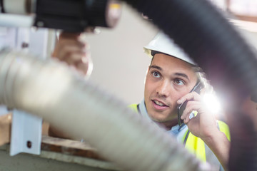 Technician at work talking on cell phone