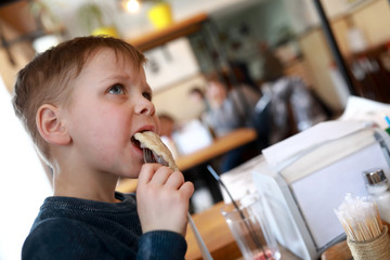 Child eating cherry dumplings