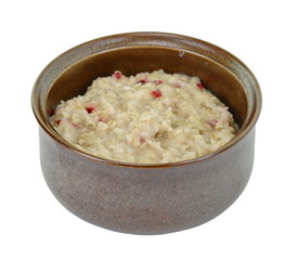 Cooked whole porridge oats in white ceramic bowl isolated on white. Bowl with prepared oatmeal. Tasty oatmeal in bowl for breakfast.